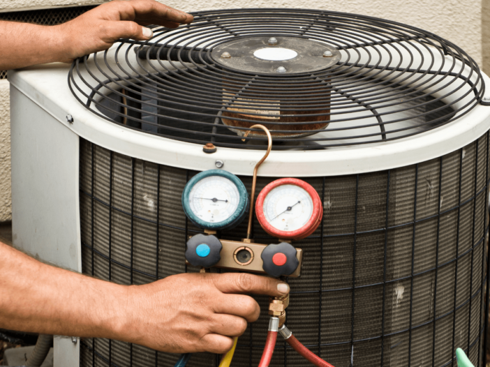 Technician inspecting AC Unit