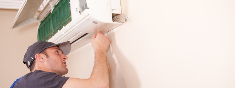 HVAC technician working on a ductless mini-split unit