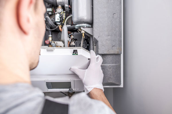 Technician repairing furnace