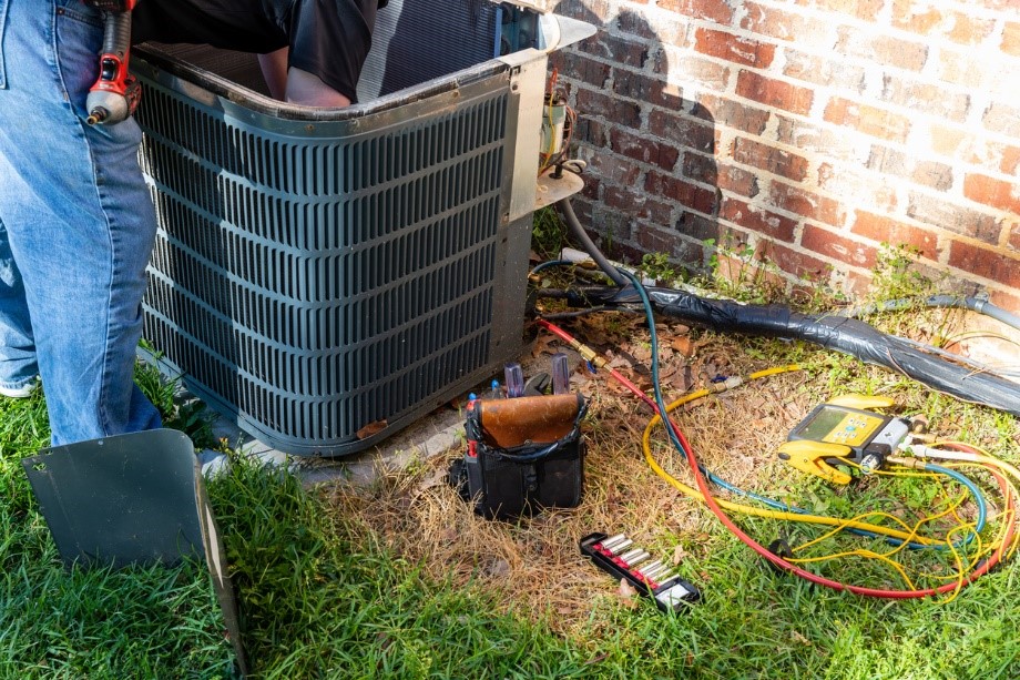 HVAC technician performing an AC maintenance service