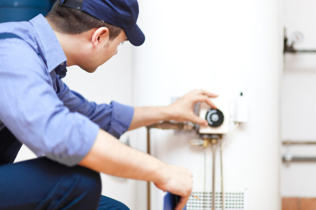 Plumber checking a water heater after a repair service 